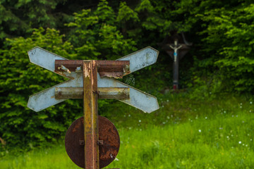 St. Andrews cross in nature with a jesus on a crucifix seen in the background. Concept photo of a...