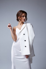 Beautiful sexy woman makeup wear fashion summer collection clothes style party office dress code wedding jacket slim body pretty face model accessory jewelry brunette hair jewelry white bride.