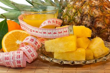 The dessert of fruit, a glass of juice and centimeter closeup on the table