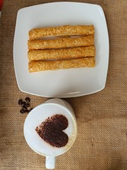 cheese sticks and a cup of hot cappucino