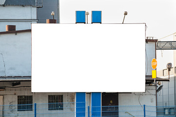Obraz premium Blank white advertising billboard in the front of the factory building