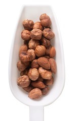 hazelnuts in a sppon isolated on white background
