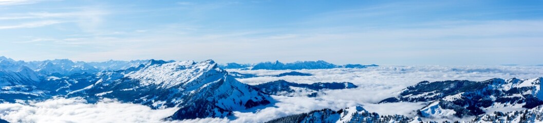 Fototapeta na wymiar beautiful mountain panorama snow covered swiss alps. panoramic picture of the snowy mountains in switzerland, sunny blue sky