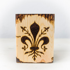 the ancient art of pyrography, wood and fire, the symbols of the city of Florence