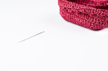 Crochet heart shaped basket and needle isolated on white background. Copy space.