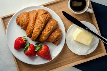 croissant with fresh strawberries and coffee 