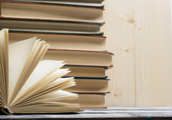 Open book, hardback books on wooden table. Back to school. Copy space