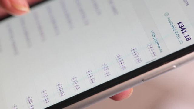 Scrolling through online bank transactions on a smartphone