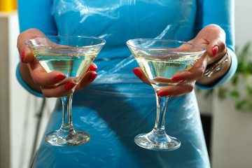 Two glasses of champagne in hand
