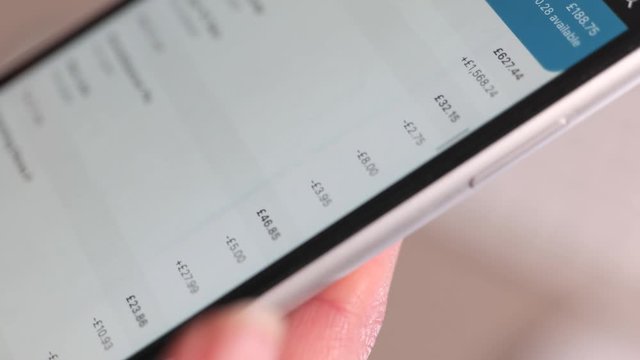 Scrolling through online bank transactions on a smartphone