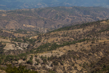 Fototapeta na wymiar Mountains and hills on the road to Quiche in Guatemala - mountains with few trees - environmental deforestation