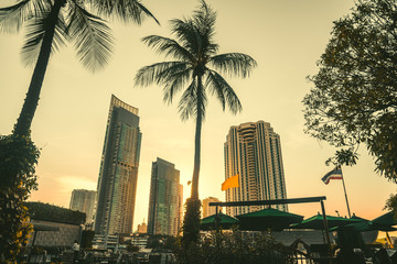 Fototapeta na wymiar Sunset in the City. Setting Sun Atmosphere in Tropical Climate City.