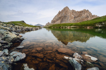 The Rocca La Meja, famous mountain peak in che Alps of Piedmont, italy, with the nearby lake and reflections on the water surface