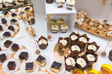 Sweet dessert table or candy bar. Candy bar with tiramisu, cakes, cake pops, close up.