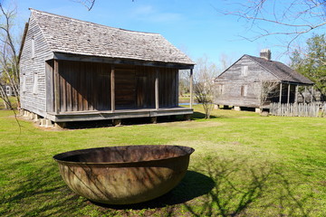 The view of an old plantation house with an iron metal bowl