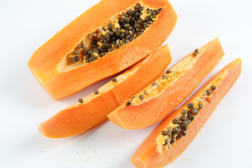 Half and slices papaya isolated on white.