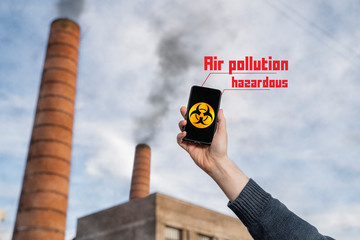 Hazardous air pollution, man measuring pollution with smartphone app concept