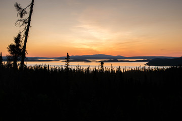 Naklejka na ściany i meble landscape of a sunset. Lake Manicouagan in Quebec. Mountain landscape with lake