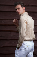 Portrait of handsome young man on wooden background.