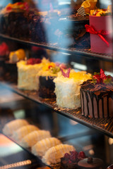 Different types of cakes in pastry shop glass display