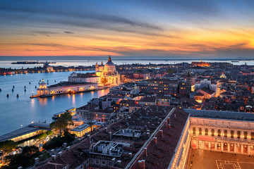 Naklejka premium Sunset skyline of Venice with Basilica Santa Maria della Salute and Piazza San Marco