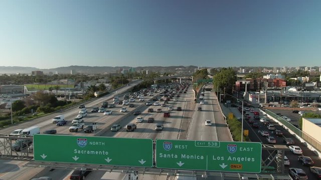 Aerial view of congested urban traffic on a Los Angeles freeway during the day.