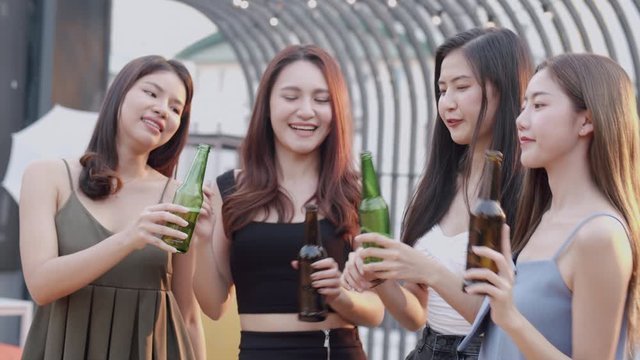 Group of teenager friends having fun at rooftop party, drinking beer or dance and enjoying  together celebrate daytime 