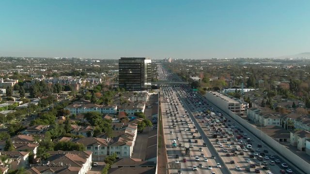 Aerial view of freeway traffic on I-405 interstate in urban Los Angeles with cars below during the day.