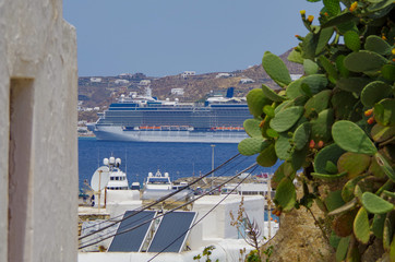 Panoramic view over Mykonos Town and Little Venice with beautiful landscape and modern cruise ship...