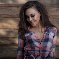 Fototapeta premium Portrait of beautiful young girl on wooden background.