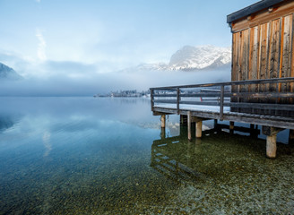 Fototapeta na wymiar Winter Lake Landscape with wooden boathouse at sunrise