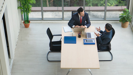 business background of two businessmen having discussion together in office