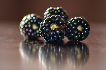 Macro shot of organic , fresh and healthy blackberry , blackberries on a wooden brown background