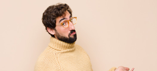 young cool man looking puzzled, confused and stressed, wondering between different options, feeling...