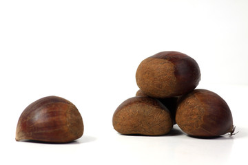 a pile of sweet chestnuts isolated on white background