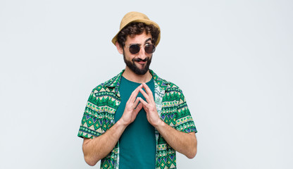 young tourist man scheming and conspiring, thinking devious tricks and cheats, cunning and...