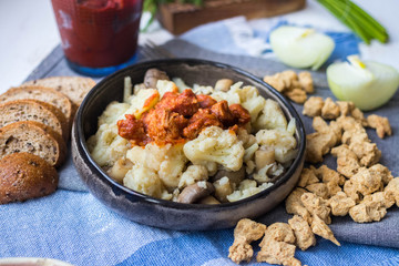 Meat substitute soy chunks with cauliflower vegan lunch food or dinner. Vegan meat with tomato paste cooked. Healthy food