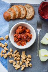 Soy meat, soy chunks with tomato paste and onion. Texturized soya meat substitute. Vegan food.