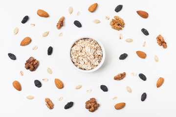 Oat flakes, nuts and raisins. Healthy eating concept. Top view.