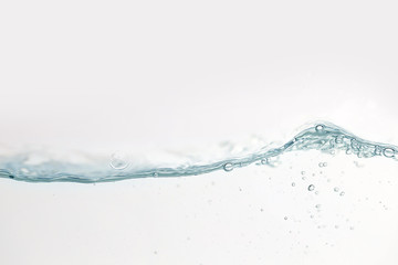 Close up water splash with air bubbles. Fresh and clean surface aqua flowing in wave and clean water on white background isolated. Advertising image with free space for your work