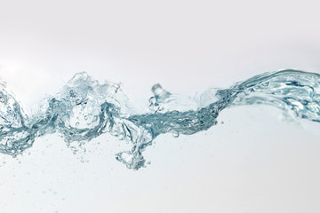 Close up blue water splash with air bubbles on white background isolated. Advertising image with free space for your work