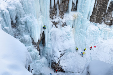 Ice climbers on frozen Upper Falls in Johnston Canyon in Banff National Park, Alberta, Canada