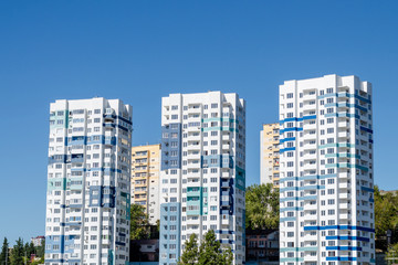 Fototapeta na wymiar Three tall light blue modern apartment buildings. Close-up
