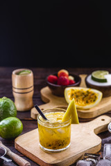 Brazilian caipirinha, Brazilian cocktail made with passion fruit, cachaça and sugar. Caipirinha, sugar, fresh passion fruit and cachaça or vodka ingredients. Summer drink, served cold in Brazil.