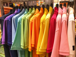 Rainbow or colorful polo shirts on hanger in shopping mall
