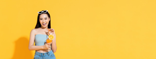 Asian woman in summer outfit with orange juice on banner background
