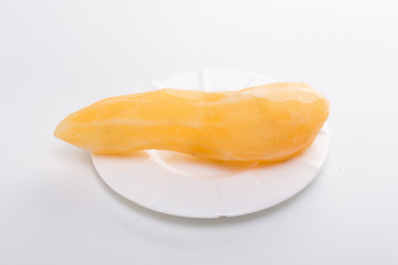 Smallanthus sonchifolius on the white plate, he in the white background, is a nutritional health of the wild plant fruit, pharyngeal inhibition