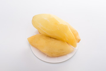 Smallanthus sonchifolius on the white plate, he in the white background, is a nutritional health of the wild plant fruit, pharyngeal inhibition