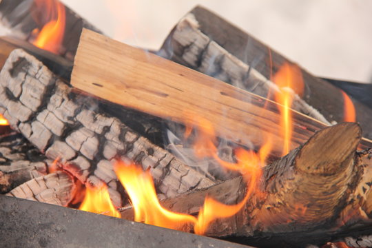 log in the flames. burning fire in the grill is large. 
