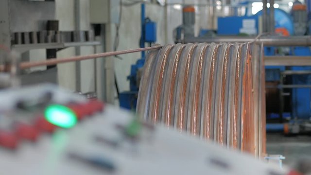 Production of copper cable. Rotating shafts with copper wire. Cable plant